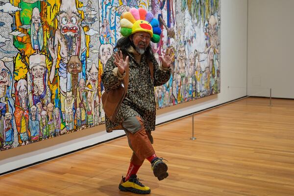 Takashi Murakami greets visitors to an exhibit of his art at the Cleveland Museum of Art in Cleveland, Thursday, May 15, 2025. (AP Photo/Sue Ogrocki)