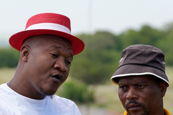 Mzwandile Mkwayi, left, and Mandla Charles, spent three days volunteering going up and down in a cage to bring out bodies and survivors at a mine, speak to journalists in Stilfontein, South Africa, Thursday, Jan. 16, 2025. (AP Photo/Themba Hadebe)