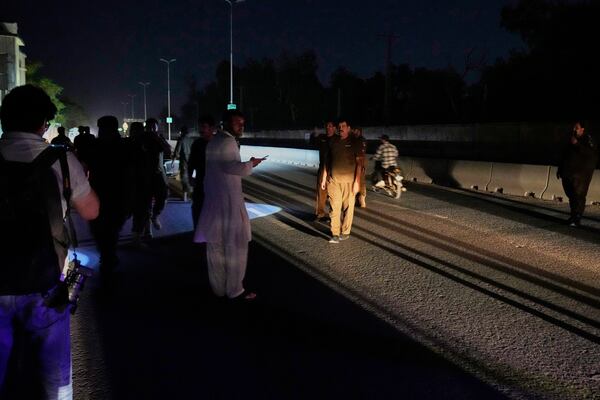 Police officers remove vehicles and people from the main entry of Nur Khan airbase following Indian missile strike on airbase, in Rawalpindi, Pakistan, Saturday, May 10, 2025. (AP Photo/Anjum Naveed)