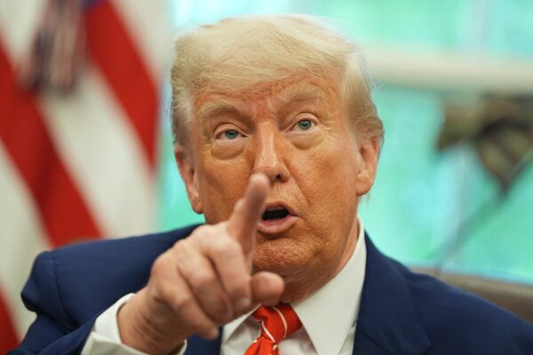President Donald Trump gestures as he speaks with reporters after announcing a trade deal with United Kingdom in the Oval Office of the White House, Thursday, May 8, 2025, in Washington. (AP Photo/Evan Vucci)
