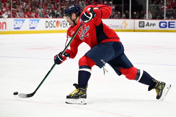 Washington Capitals left wing Alex Ovechkin (8) shoots the puck in the first period of Game 2 of a first-round NHL hockey playoff series against the Montreal Canadiens Wednesday, April 23, 2025, in Washington. (AP Photo/Nick Wass)