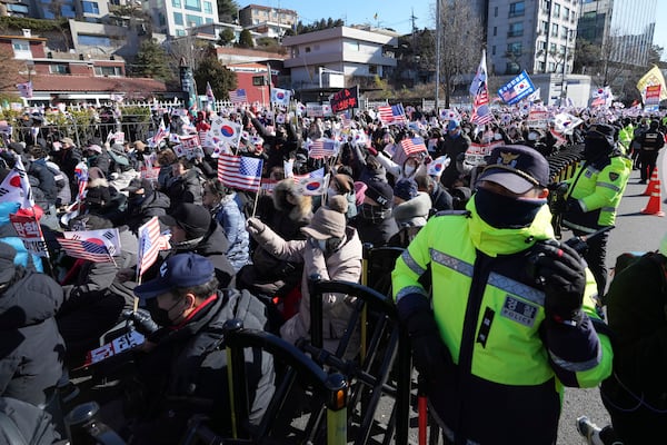 Supporters of impeached South Korean President Yoon Suk Yeol stage a rally after hearing a news that a court issued warrants to detain Yoon, near the presidential residence in Seoul, South Korea, Tuesday, Dec. 31, 2024. (AP Photo/Lee Jin-man)