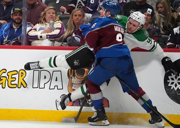 Colorado Avalanche defenseman Cale Makar, front, checks Dallas Stars right wing Mikko Rantanen, back, in the second period of Game 6 of an NHL hockey first-round playoff series Thursday, May 1, 2025, in Denver. (AP Photo/David Zalubowski)