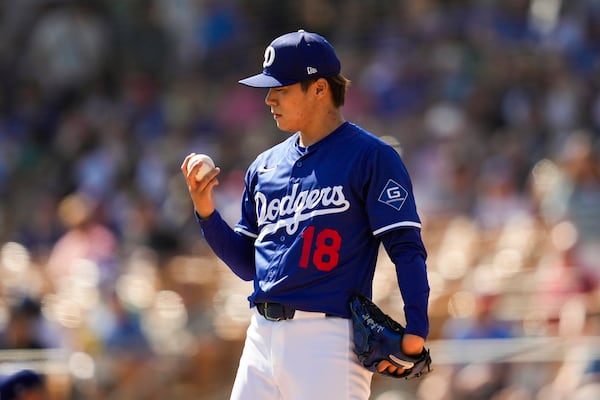 Los Angeles Dodgers pitcher Yoshinobu Yamamoto stands on the mound during the first inning of a spring training baseball game against the Chicago Cubs, Thursday, Feb. 20, 2025, in Phoenix. (AP Photo/Ashley Landis)