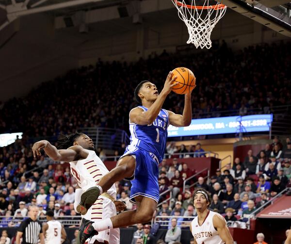 Duke guard Caleb Foster (1) lays up the ball in front of Boston College forward Jayden Hastings (22) during the first half of an NCAA college basketball game Saturday, Jan. 18, 2025, in Boston. (AP Photo/Mark Stockwell)