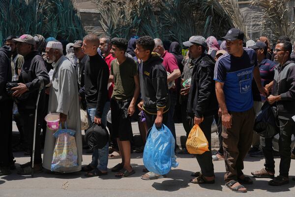 Palestinians line up for food distribution in Deir al-Balah, Gaza Strip, Friday, May 30, 2025. (AP Photo/Abdel Kareem Hana)