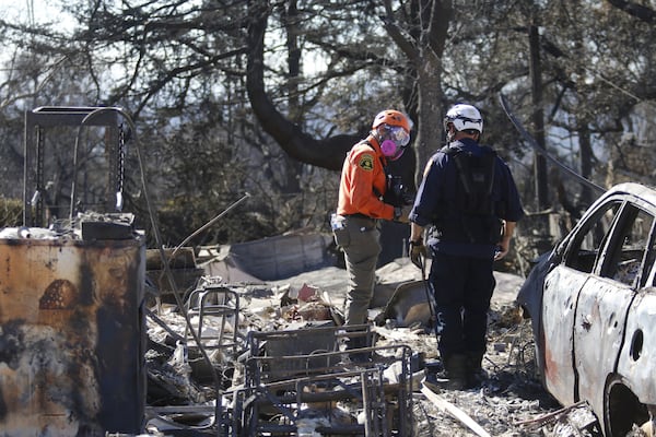 Search and rescue workers dig through the rubble left behind by the Eaton Fire, in Altadena, Calif., Tuesday, Jan. 14, 2025. (AP Photo/Ty O'Neil)