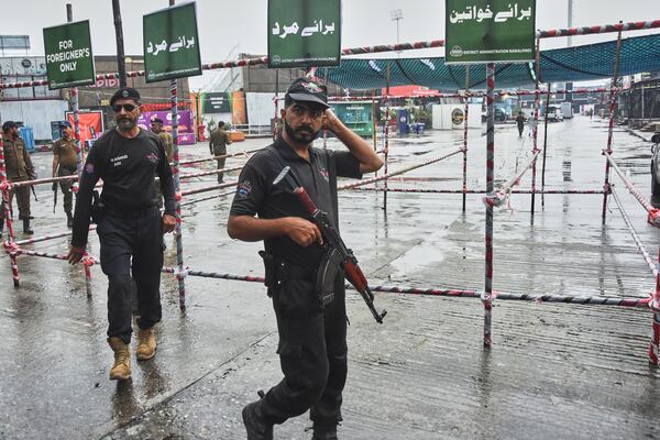 Police officers stand guard at an entry point to Pindi Cricket Stadium following the crash of a suspected Indian drone in the parking area, in Rawalpindi, Pakistan, Thursday, May 8, 2025. (AP Photo/W.K. Youszai)