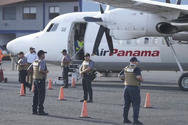 Security officers stand on the tarmac before Secretary of State Marco Rubio arrives to watch people board a repatriation flight bound for Colombia at Albrook Airport in Panama City, Monday, Feb. 3, 2025. (AP Photo/Mark Schiefelbein, Pool)