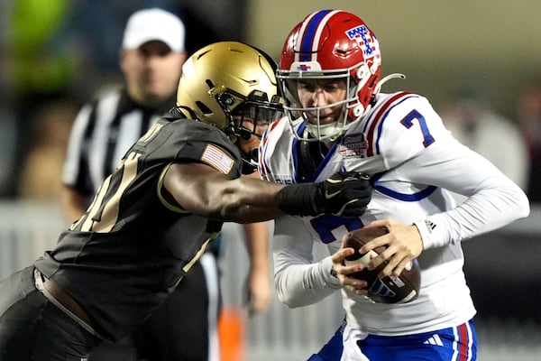 Army linebacker Eric Ford, left, rushes Louisiana Tech quarterback Evan Bullock (7) who was attempting to throw a pass during the first half of the Independence Bowl NCAA college football game, Saturday, Dec. 28, 2024, in Shreveport, La. (AP Photo/Rogelio V. Solis)