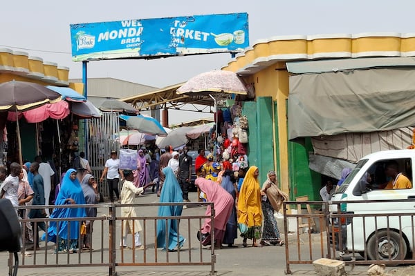 People walk past the main market in Maiduguri, Nigeria, Saturday, March 15, 2025. (AP Photo/Joshua Olatunji)