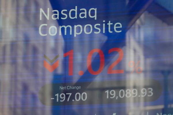 Times Square is reflected in the windows of the Nasdaq MarketSite in New York, Tuesday, Feb. 25, 2025. (AP Photo/Seth Wenig)