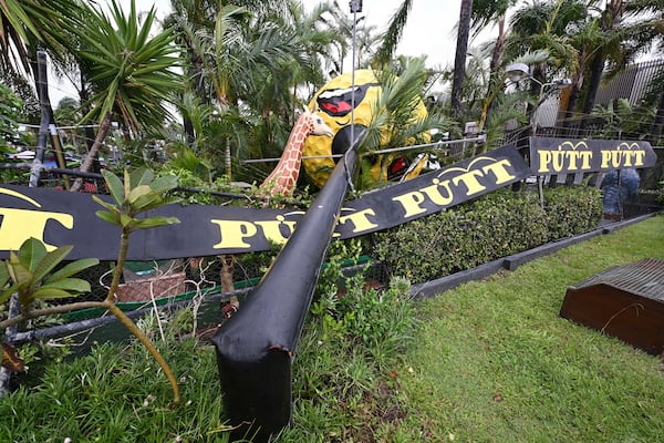 A giant golf ball sign is seen fallen outside a mini golf complex at Mermaid Beach on the Gold Coast, Australia, Saturday, March 8, 2025. (Dave Hunt/AAP Image via AP)