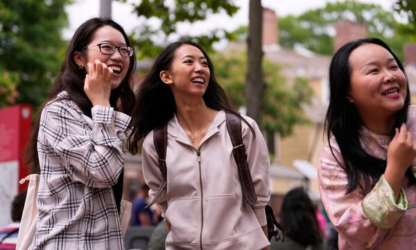 Yurong "Luanna" Jiang, center, who delivered a speech at her Harvard University commencement, jokes with her college friends Helen Ji, left, and Cynthia Luo, Friday, May 30, 2025, in Cambridge, Mass. (AP Photo/Charles Krupa)