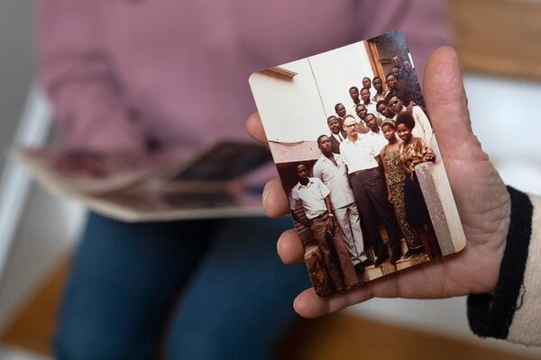 Anna Eisenberg, left, and her mother Cathy Votaw, 69, look at photographs of Votaw's father, Albert Votaw, during his service with USAID in West Africa, Thursday, Feb. 27, 2025, at their home in Washington. (AP Photo/Jacquelyn Martin)