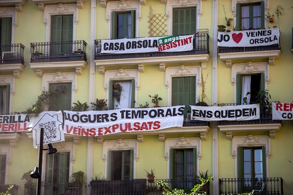 FILE - A block of flats, which is under threat of eviction, is photographed in downtown Barcelona, Spain, Wednesday, July 10, 2024.The banner in the center reads in Catalan: "temporary rental housing: neighbours evicted". (AP Photo/Emilio Morenatti, File)