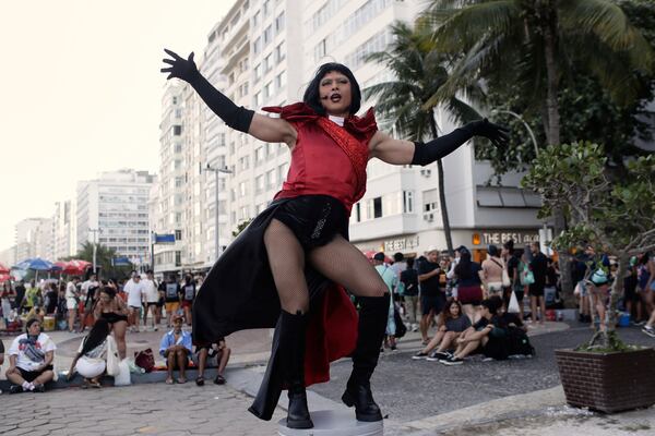 A fan strikes a pose as she waits for the start of Lady Gaga's free concert on Copacabana beach in Rio de Janeiro, Saturday, May 3, 2025. (AP Photo/Bruna Prado)