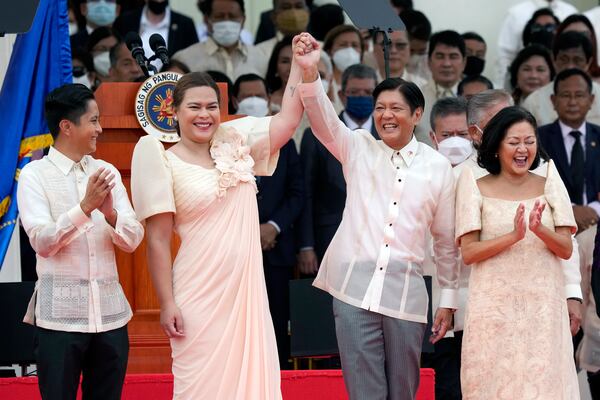 FILE - President Ferdinand Marcos Jr., center right, and Philippine Vice President Sara Duterte, daughter of former Philippine President Rodrigo Duterte, greet during the inauguration ceremony at National Museum on June 30, 2022 in Manila, Philippines. (AP Photo/Aaron Favila, file)