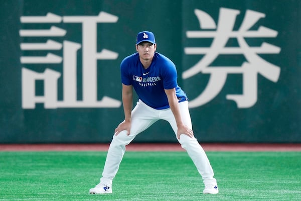 Los Angeles Dodgers two-way player Shohei Ohtani warms up during the official training, Friday, March 14, 2025, in Tokyo, ahead of the start of the MLB Tokyo Series at the Tokyo Dome. (AP Photo/Eugene Hoshiko)