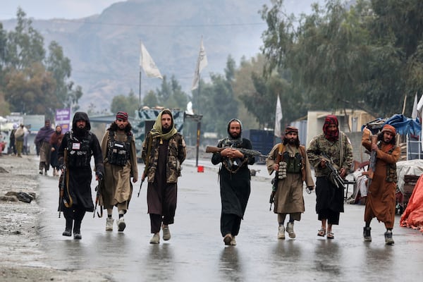 Taliban fighters patrol near the closed Torkham border with Pakistan, where Pakistani and Afghan forces exchanged fire overnight, in Torkham, Afghanistan, Monday, March 3, 2025.(AP Photo/Shafiullah Kakar)