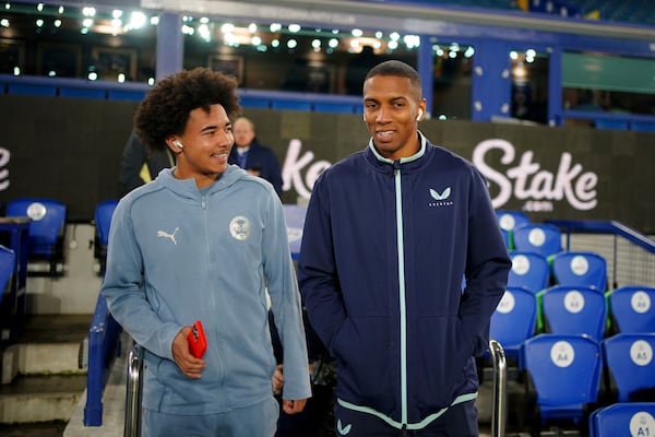 Everton's Ashley Young, right, speaks with his son, Peterborough United's Tyler Young, before the Emirates FA Cup third round match at Goodison Park, Liverpool, England, Thursday Jan. 9, 2025. (Peter Byrne/PA via AP)