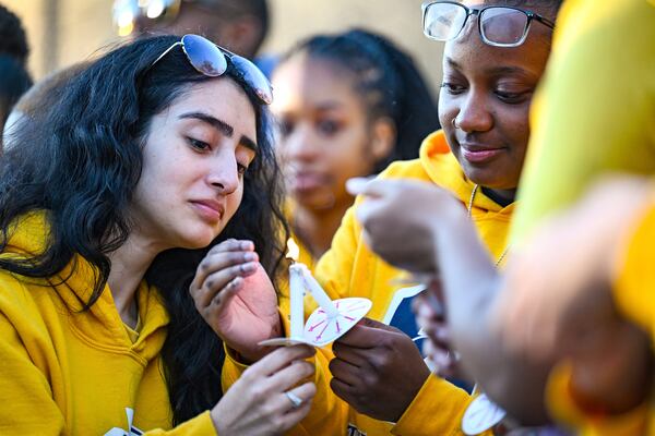 Jaylen Lewis, right, helps light Virginia Olide's candle during a vigil for Caleb Wilson outside of Southern University's Smith-Brown Student Union on Wednesday, March 5, 2025, in Baton Rouge, La. (Javier Gallegos/The Advocate via AP)