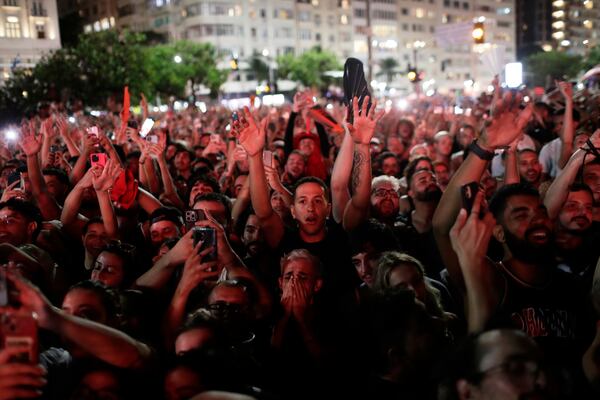 Fans cheer as they watch Lady Gaga rehearse a day ahead of her free concert, on Copacabana beach, in Rio de Janeiro, Friday, May 2, 2025. (AP Photo/Bruna Prado)