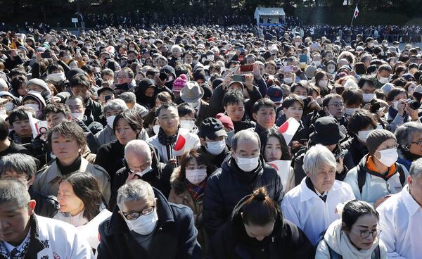 Well-withers gather as Japanese Emperor Naruhito, unseen, accompanied by other royal family members, appears on the balcony of the Imperial Palace in Tokyo on the emperor's 65th birthday, Sunday, Feb. 23, 2025. (Kyodo News via AP)