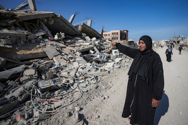 Manual Aslim reacts next to the ruins of her destroyed home, days after the ceasefire deal between Israel and Hamas came into effect, in Rafah, southern Gaza Strip, Tuesday, Jan. 21, 2025. (AP Photo/Abdel Kareem Hana)