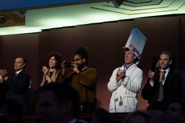 Brian McCann, dressed as the FedEx Pope, looks to Conan O'Brien at the start of the 25th Annual Mark Twain Prize for American Humor Celebrating Conan O'Brien, Sunday, March 23, 2025, at the Kennedy Center for the Performing Arts in Washington. (AP Photo/Kevin Wolf)