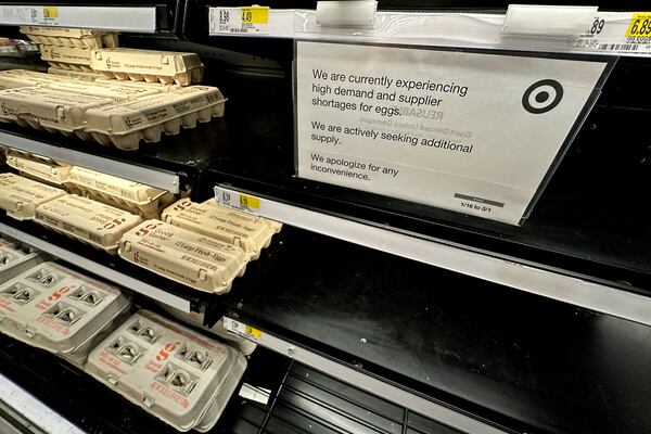 A sign is mounted on a shelve of eggs at a grocery store in Chicago, Saturday, Feb. 8, 2025. (AP Photo/Nam Y. Huh)