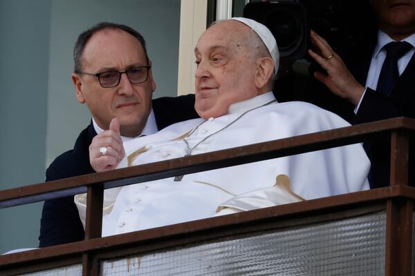 Pope Francis appears at a window of the Agostino Gemelli Polyclinic in Rome, Sunday, March 23, 2025, where he has been treated for bronchitis and bilateral pneumonia since Feb. 14. (AP Photo/Riccardo De Luca)