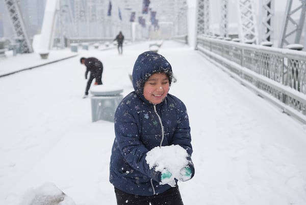 Joselyn Catlan, 9, plays in the snow Friday, Jan 10, 2025, in Nashville, Tenn. (AP Photo/George Walker IV)