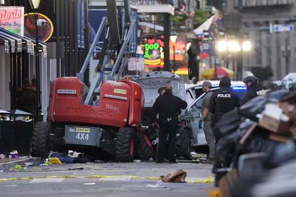 Emergency services attend the scene on Bourbon Street after a vehicle drove into a crowd on New Orleans' Canal and Bourbon Street, Wednesday Jan. 1, 2025. (AP Photo/Gerald Herbert)