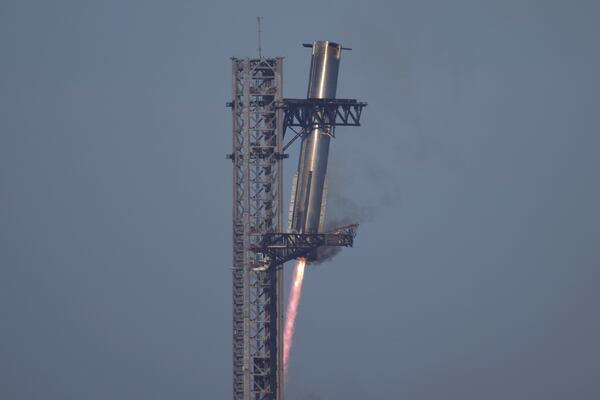 SpaceX's mega rocket Starship booster returns to the launch pad during a test flight from Starbase in Boca Chica, Texas, Thursday, Jan. 16, 2025. (AP Photo/Eric Gay)