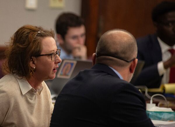 Former District Attorney Jackie Johnson talks with Jason Clark one of her defense lawyers in her trial on charges violating her oath of office and obstruction of justice. (Michael Hall/The Brunswick News via AP, Pool)