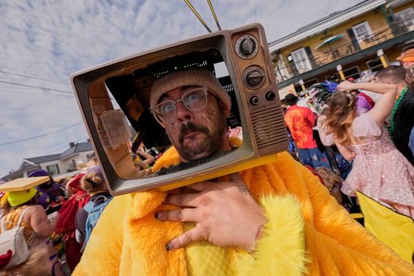 Tony Burgesen has some fun during the Society of Saint Anne's parade on Mardi Gras Day, Tuesday, March 4, 2025 in New Orleans. (AP Photo/Gerald Herbert)