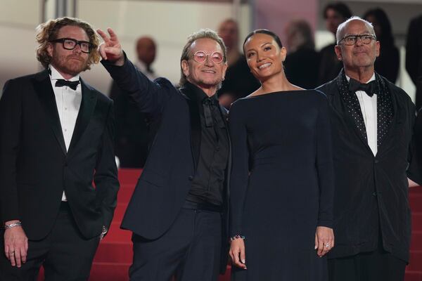 Erik Messerschmid, from left, Bono, Kelly McNamara, and Jon Kamen pose for photographers upon arrival at the premiere of the film 'Bono: Stories of Surrender' at the 78th international film festival, Cannes, southern France, Friday, May 16, 2025. (AP Photo/Natacha Pisarenko)