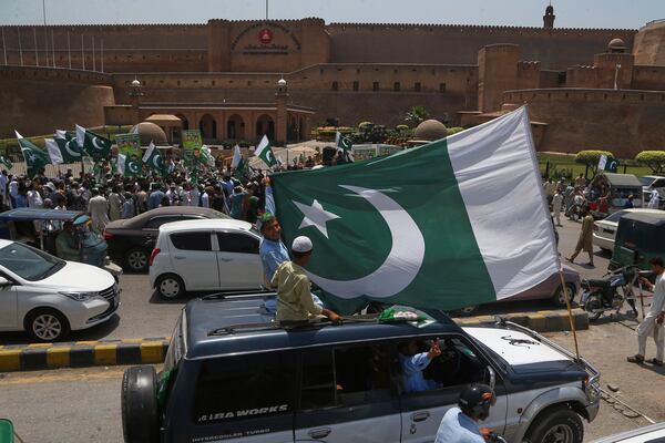 People with national flags take part in a demonstration to show their support with Pakistan Army, a day after the ceasefire between Indian and Pakistan was announced, in Peshawar, Pakistan, Sunday, May 11, 2025. (AP Photo/Muhammad Sajjad)