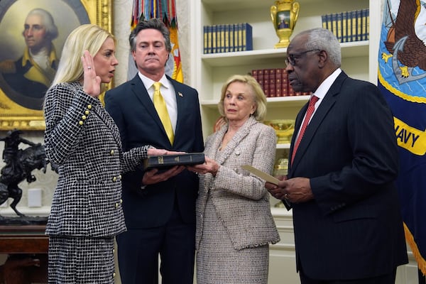 Pam Bondi is sworn in as Attorney General by Supreme Court Associate Justice Clarence Thomas, right, as partner John Wakefield and mother Patsy Bondi look on, in the Oval Office of the White House, Wednesday, Feb. 5, 2025, in Washington. (AP Photo/Evan Vucci)