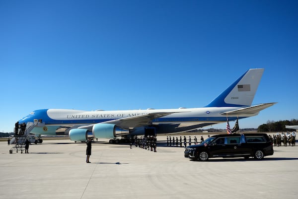 The hearse carrying flag-draped casket of former President Jimmy Carter arrives at Dobbins Air Reserve Base in Marietta, Ga., Tuesday, Jan. 7, 2025. Carter died Dec. 29 at the age of 100. (AP Photo/Alex Brandon, Pool)