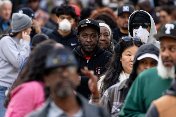 People impacted by the Eaton Fire wait in line to access Pasadena City College's gymnasium, where The Change Reaction will be handing out about 1,000 checks of between $2,500-$5,000, Tuesday, Jan. 28, 2025 in Pasadena, Calif. (AP Photo/Etienne Laurent)