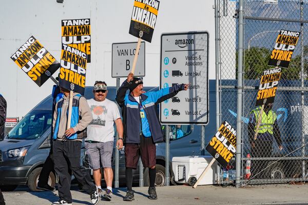 Amazon workers, on strike, picket outside an Amazon Fulfillment Center, Thursday, Dec. 19, 2024, in City of Industry, Calif. (AP Photo/Damian Dovarganes)