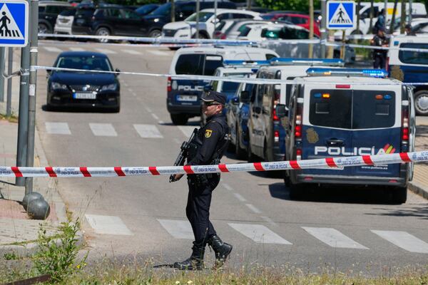 Police officers cordon off the area after an adviser to former Ukrainian president Viktor Yanukovych was shot, outside a school in Madrid, Spain, Wednesday, May 21, 2025. (AP Photo/Paul White)