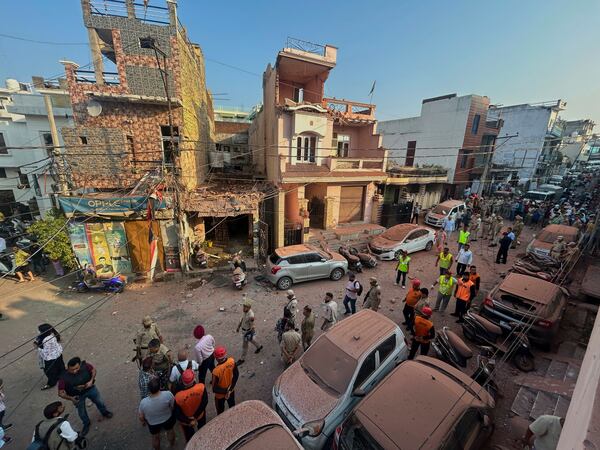 Rescuers and security personnel inspect a residential building damaged by a Pakistan's drone attack in Jammu, India, Saturday, May 10, 2025. (AP Photo/Channi Anand)