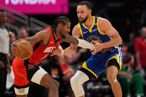 Houston Rockets guard Jalen Green, left, drives on Golden State Warriors guard Stephen Curry during the second half of Game 5 of an NBA basketball first-round playoff series, Wednesday, April 30, 2025, in Houston. (AP Photo/David J. Phillip)