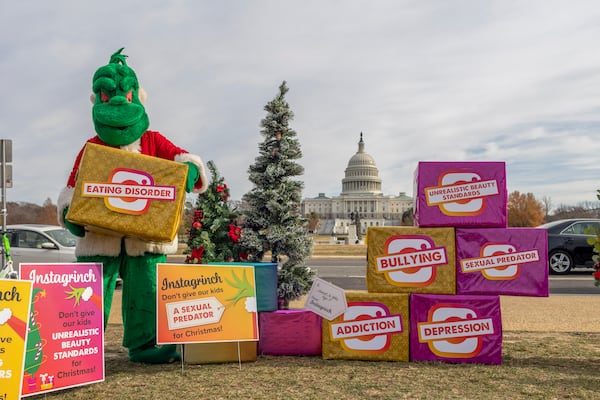 FILE - In advance of Instagram CEO Adam Mosseri's Congressional testimony, to illustrate the harms children face on social media, parent activists brought an "Instagrinch" to the Capitol building in Washington, Dec. 7, 2021. (Eric Kayne/AP Images for ParentsTogether, File)