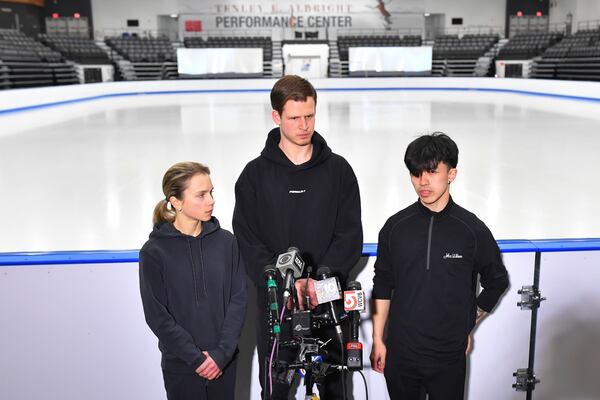 American figure skaters, from the left, Alisa Efimova, Misha Mitrofanov, and Jimmy Ma, speak to members of the media at the The Skating Club of Boston, where several athletes, coaches and family associated with the club are believed to have perished in the collision of a passenger aircraft and military helicopter in Washington, Thursday, Jan. 30, 2025, in Norwood, Mass. (AP Photo/Steven Senne)