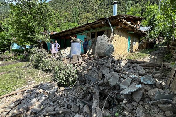 Kashmiri villagers examine damages to a house caused by overnight Indian shelling, in Shah Kot, in Neelum Vallery, a district of Pakistan's administered Kashmir, Saturday, May 10, 2025. (AP Photo/M.D. Mughal)