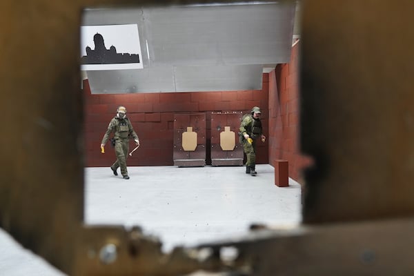 Members of the Vantaa Reservists Association practice at a shooting range in a warehouse in Kerava on the outskirts of Helsinki, Finland Monday, Dec. 2, 2024. (AP Photo/James Brooks)